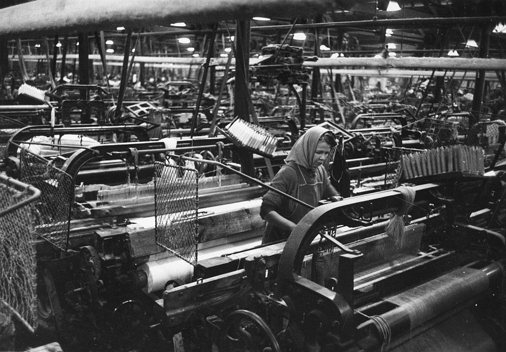 A female textile worker operating machinery at the Blackstaff Flax Spinning and Weaving Company in Belfast, 1954.