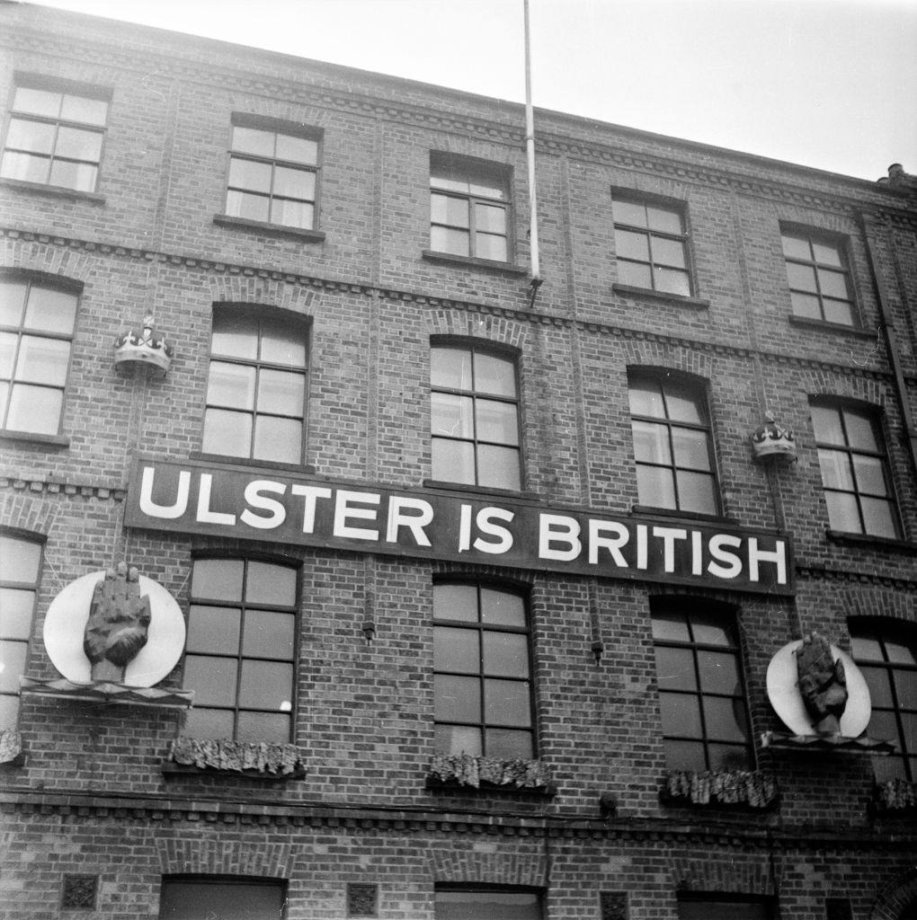 A Unionist sign reading 'Ulster Is British' on a building in Belfast, 1954.