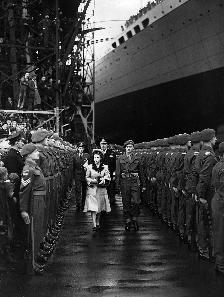 Princess Margaret Rose walks through a guard of honour at Belfast, 1955.