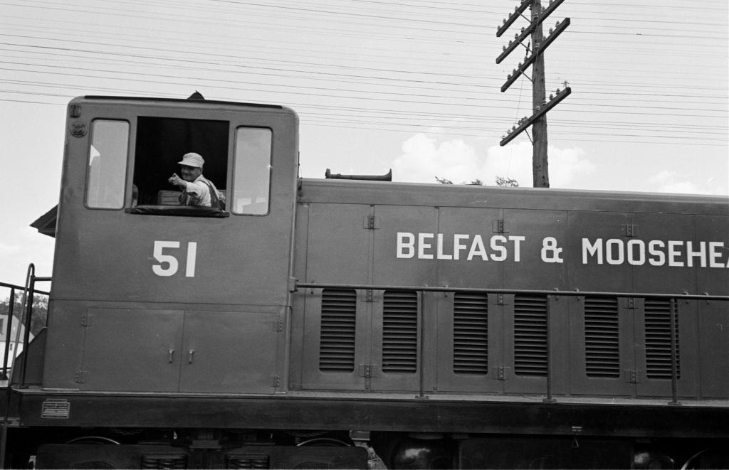 Man riding in a train at the Belfast and Moosehead Lake Railroad, 1950.