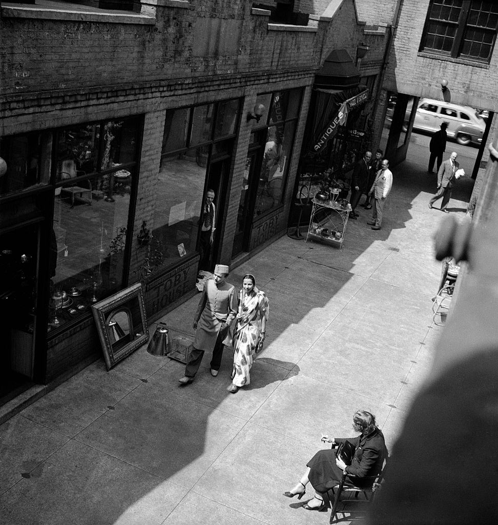 Southern Asian dancers Asoka and Sujata walking on a Brooklyn street, 1950.