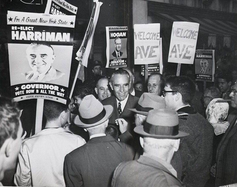 New York Governor Averell Harriman is surrounded by crowds as he leaves a store in one of Brooklyn's busiest shopping centers, 1958.