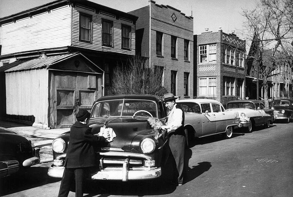 An Italian-American man and his son washing their car in Brooklyn, New York City, 1956.
