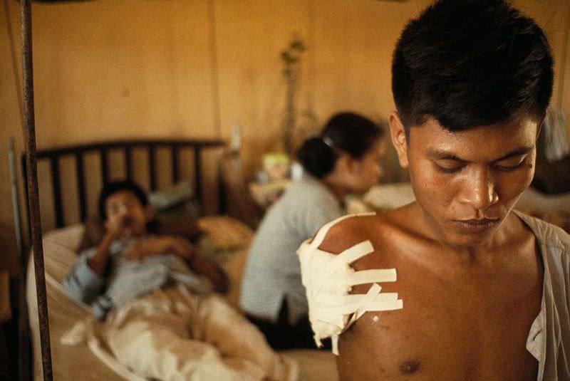 A soldier suffers after losing an arm in a battle west of Saigon in Saigon, 1965