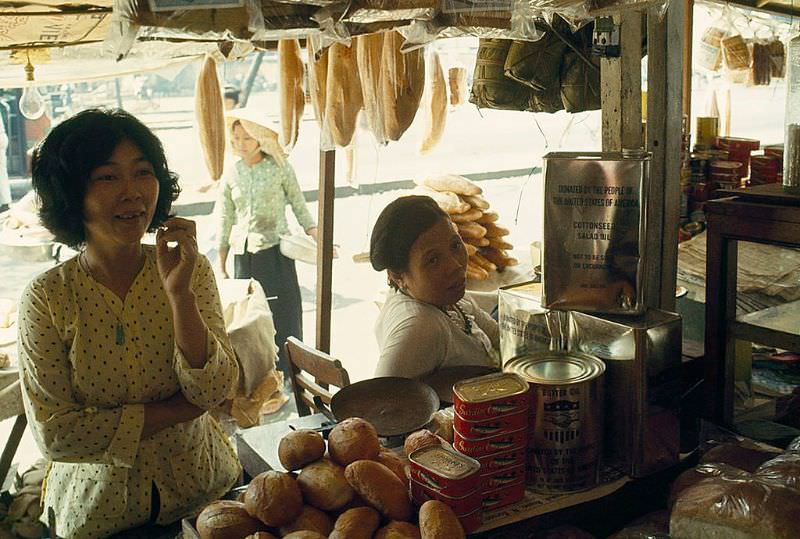 A vendor sells canned goods sent as gifts to the Vietnamese people in Saigon, 1965