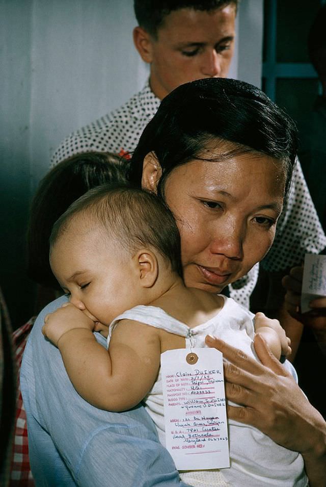 A Vietnamese nurse hugs her American ward before saying goodbye in Saigon, 1965