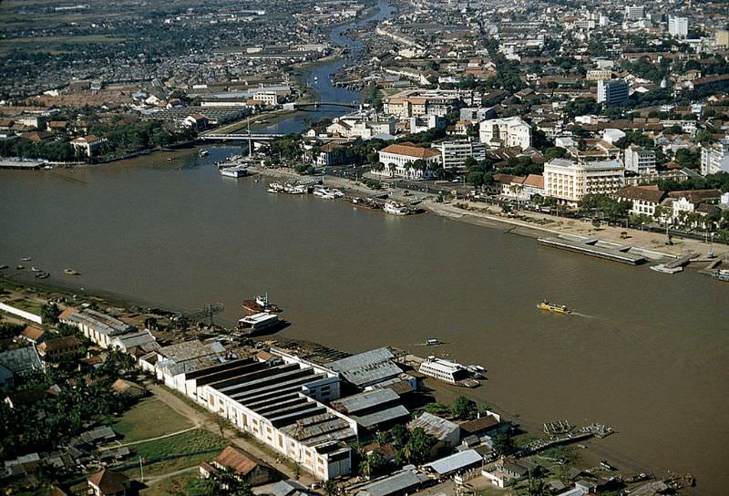 An active port and urban sprawl border the Saigon River in Saigon, 1961