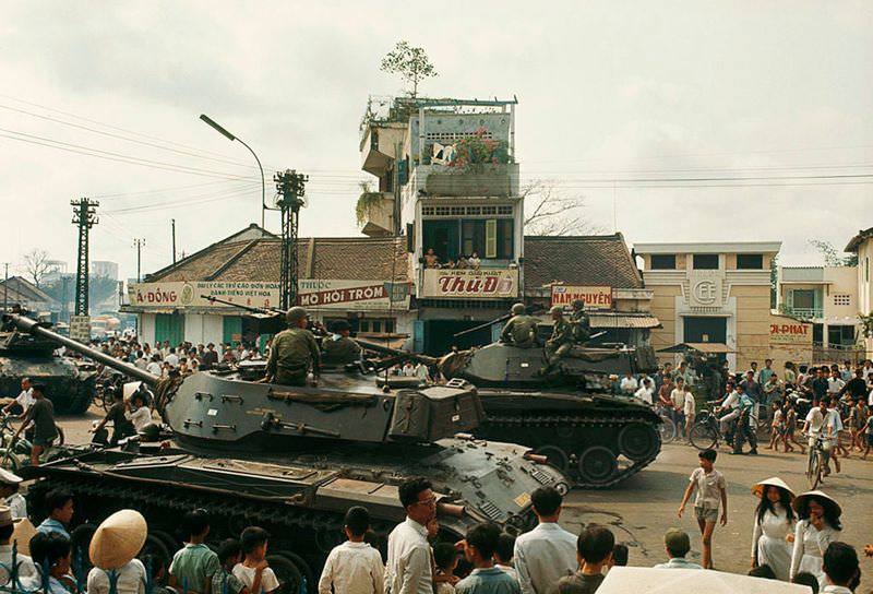 Tanks commanded by rebellious officers rumble along a city street in Saigon, 1965