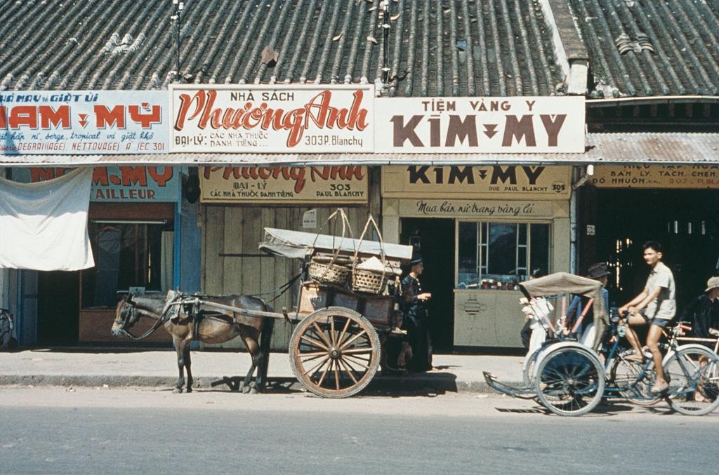 A view of shops on a street in Saigon, 1960.