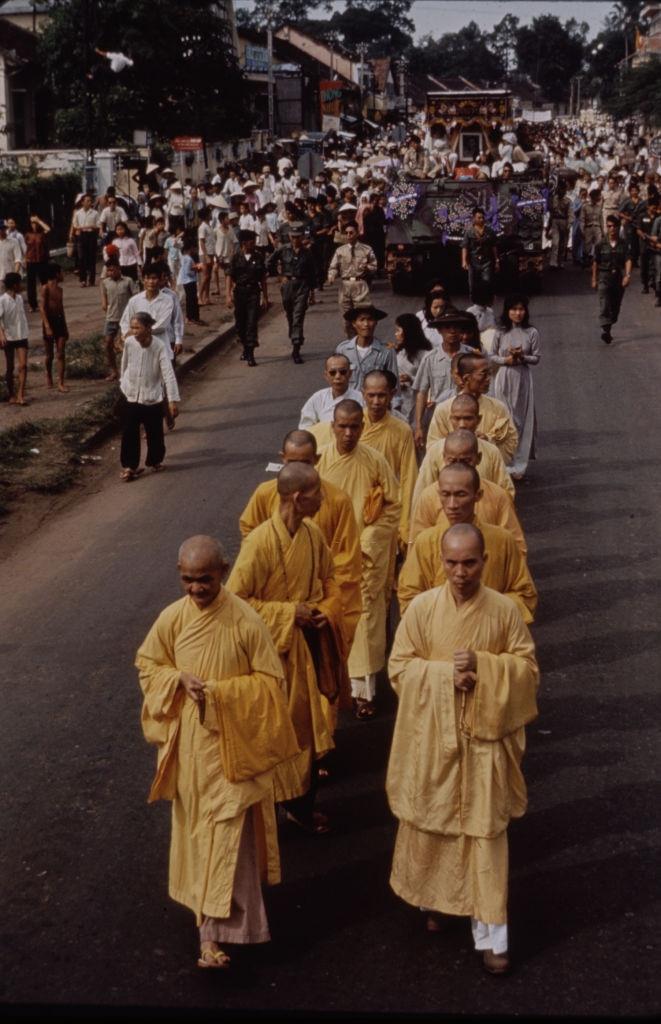 Monks walking on the street during the deposing of President Ngo Dinh Diem in Saigon, 1963.