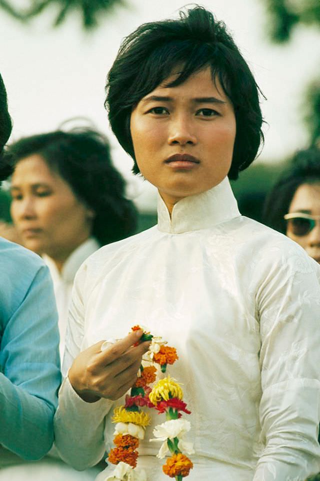 A greeter of the Women's Army Forces waits for Korean troops in Saigon, 1965