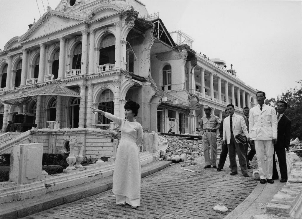 Mrs. Dinh Nhu Ngo surveying ruins of Palace bombed by Vietnamese insurrectionists, 1962.