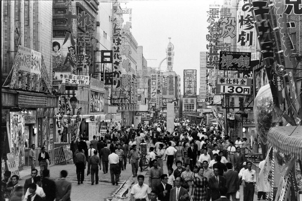 People gathering in the street to watch a film, Vietnam, August 1963