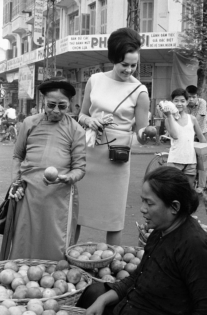 Ann Sidney (Miss world) Shopping at Market in Saigon, 1964.