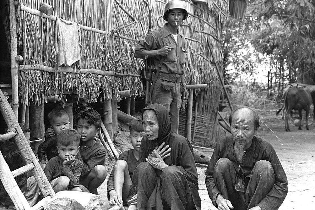 Vietnamese Army personnel interrogate villagers during a drive against the Viet Cong, 1965.