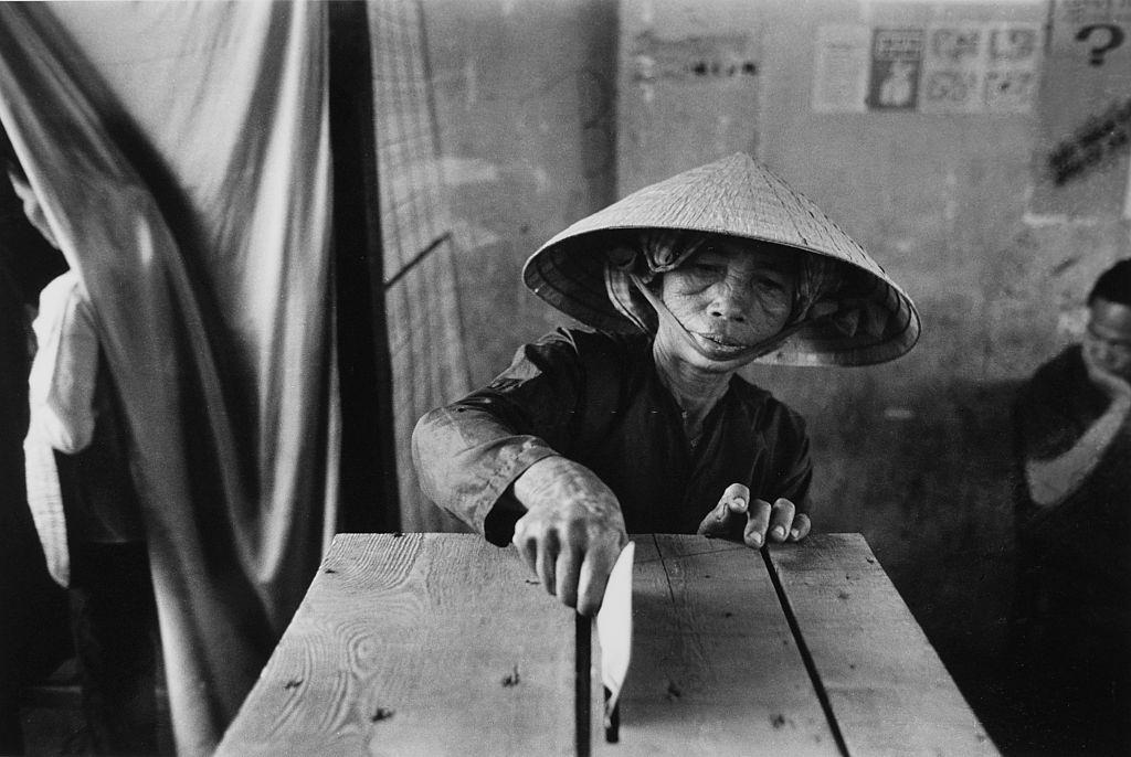 A woman putting voting-paper into the ballot-box in elections, 1969.