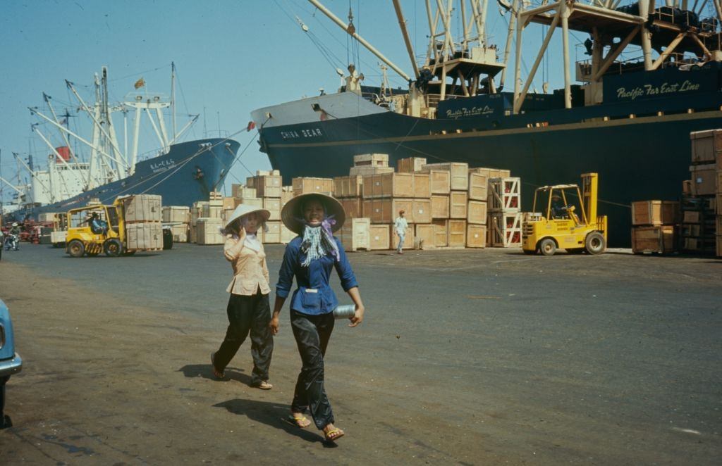 Women walking in the port at the Mekong Delta in Vietnam, 1968