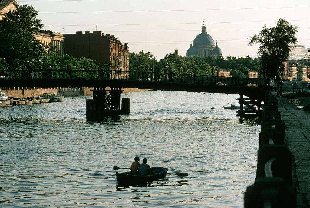 A rowboat passes beneath a bridge over one of Leningrad's many canals, 1972.