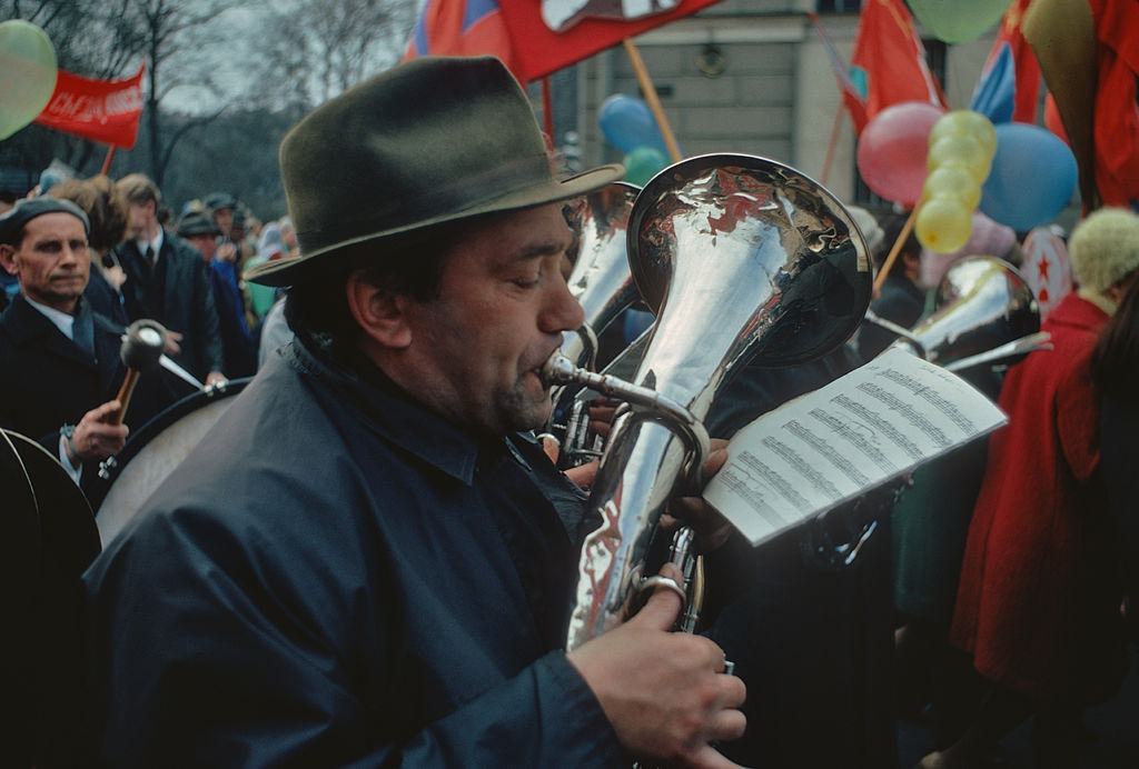 A man playing a brass instrument during May Day celebrations on Nevsky Prospekt, Leningrad, 1972.