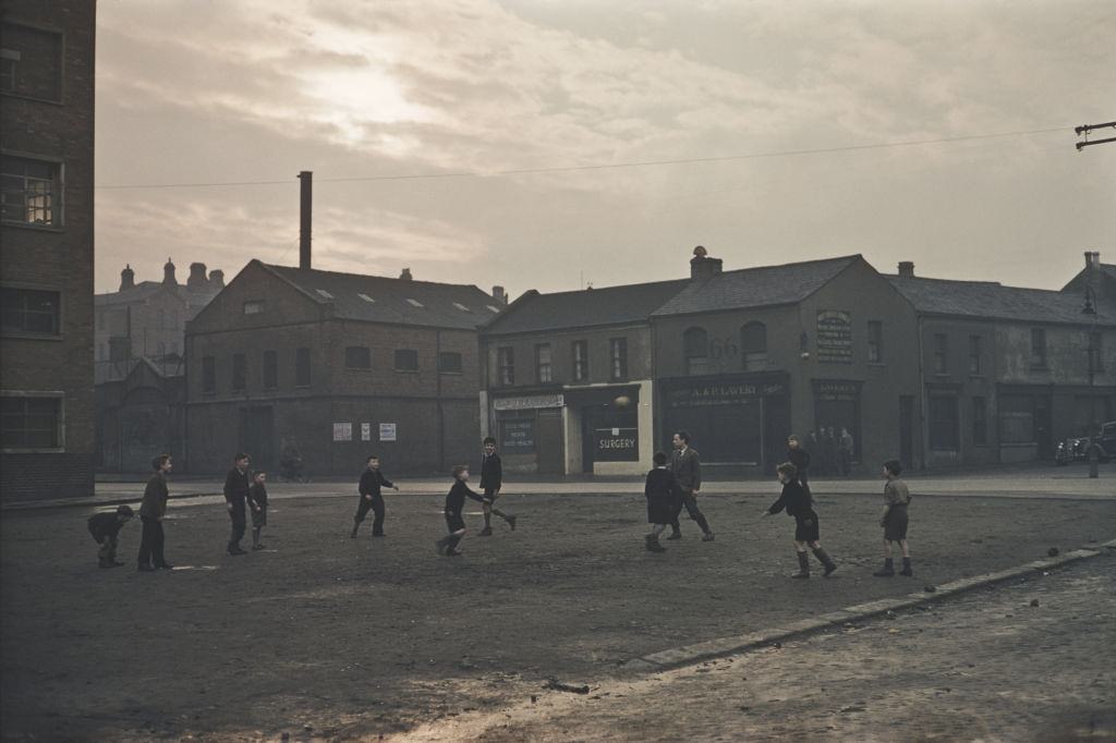 A group of boys playing football in a Belfast street, 1955.