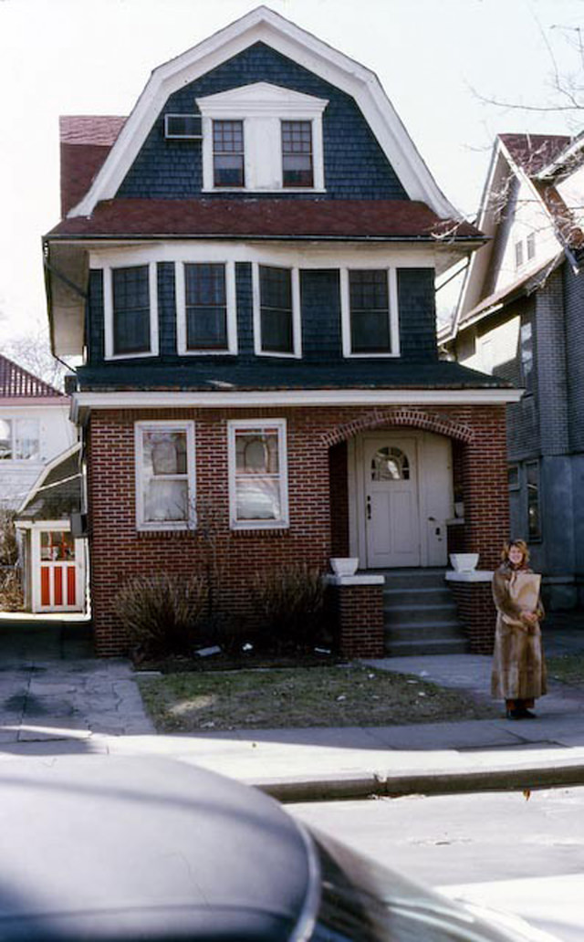 Woman stands in front of a house at 1068 East 10th Street in Flatbush, 1971