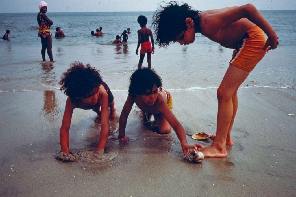 Children playing on the shore at Reis Park, a public beach in Brooklyn, New York City, 1974.