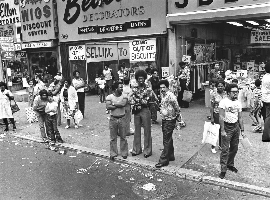 People on a crowded Brooklyn sidewalk, 1977.