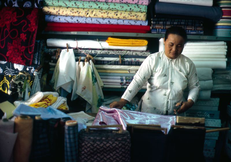 Measuring silk for an Ao Dai in Can Tho, 1968