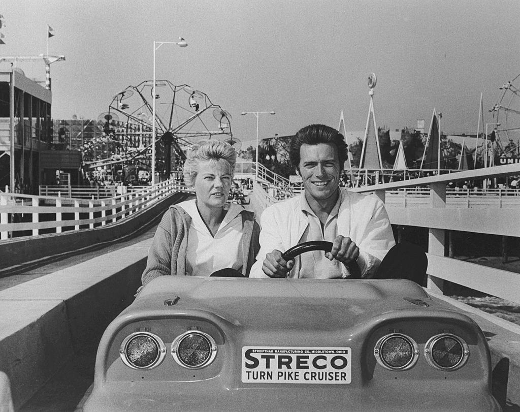 Clint Eastwood sits behind the wheel as he and his wife Maggie take a ride on the Union 76 Ocean Highway at Pacific Ocean Park, 1959.