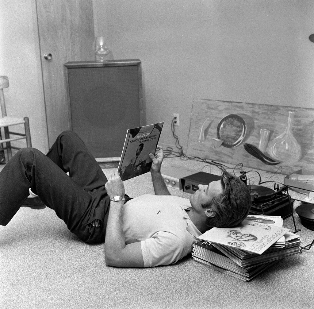 Clint Eastwood listens to records at his home, 1959.