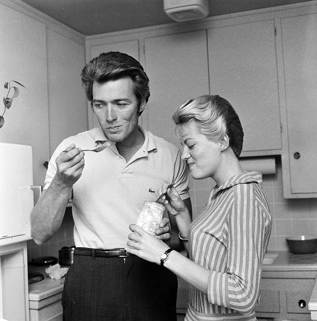 Clint Eastwood at home with his wife, Maggie, having a midday snack, 1959.