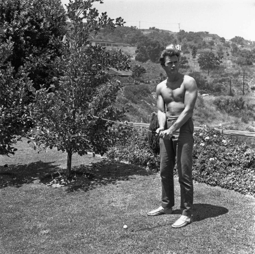 Clint Eastwood playing golf at his home in the Hollywood Hills, 1960.