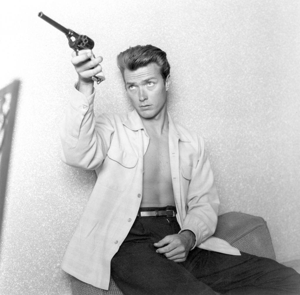 Clint Eastwood checks his gun at home on June 1, 1956.