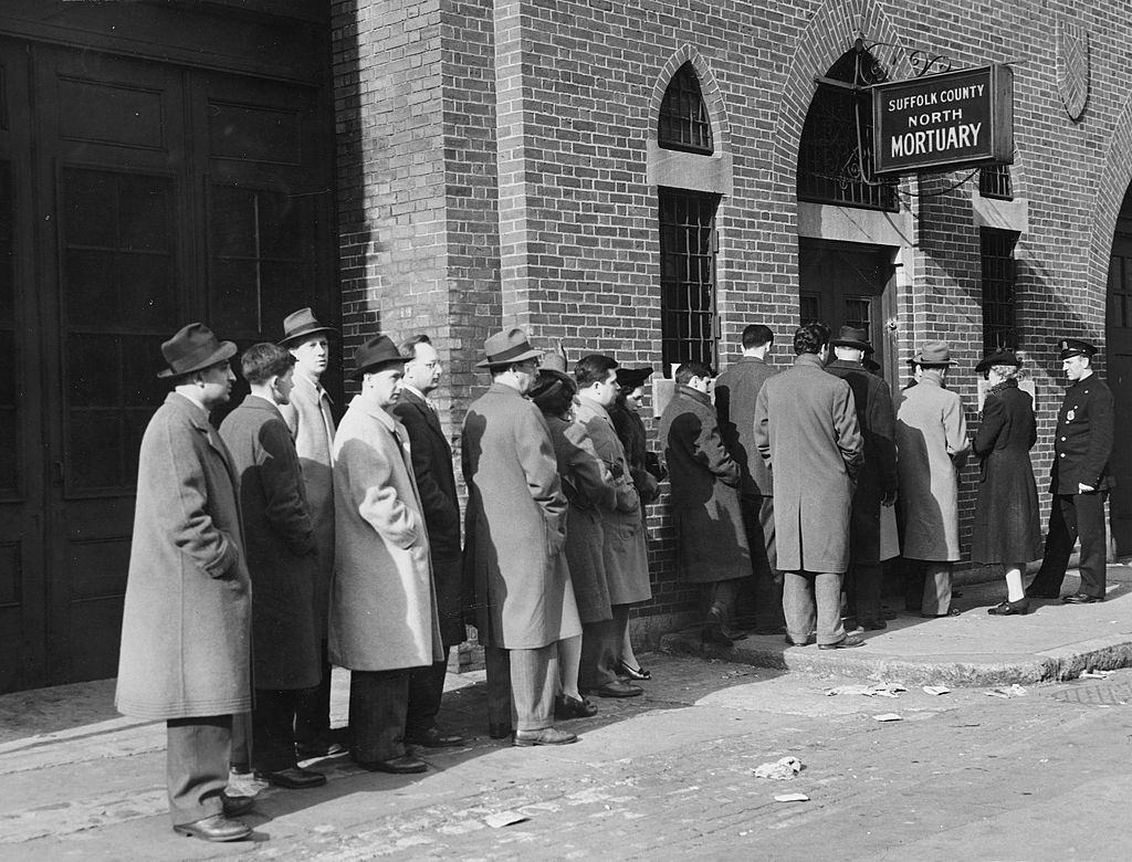 Relatives of the died people in the Cocoanut Grove nightclub fire wait in line outside a mortuary to identify the bodies of their loved ones, Boston.