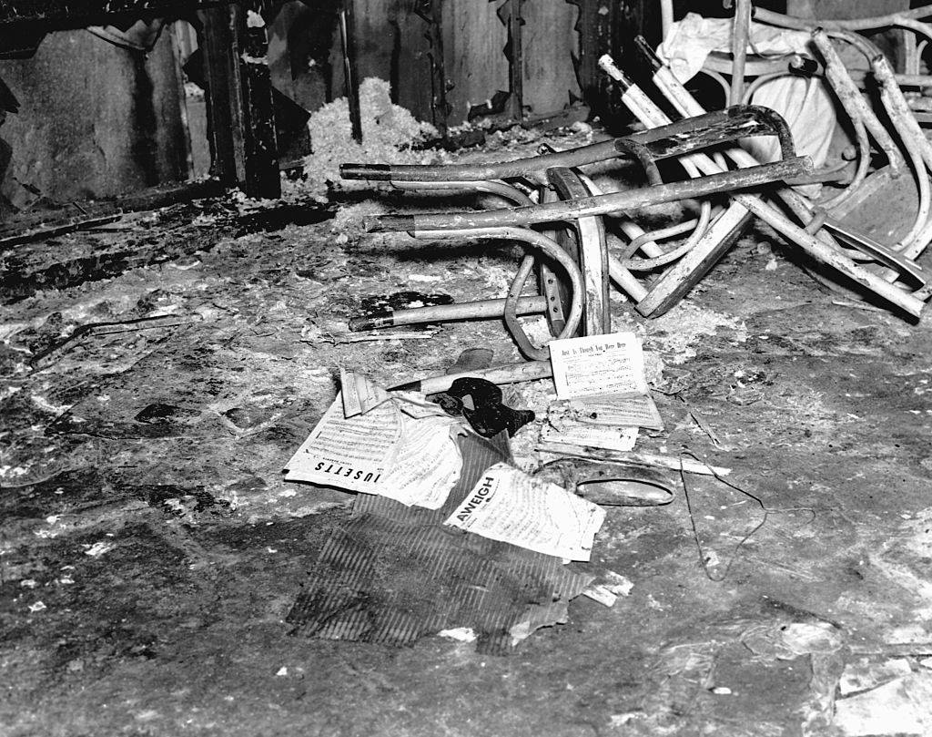 Chairs, shoes, and sheet music lie on the sidewalk outside the Cocoanut Grove nightclub in Boston on November 29, 1942.