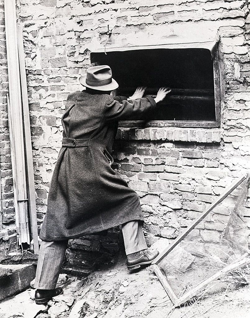 Reporter Examines Window of Cocoanut Grove.