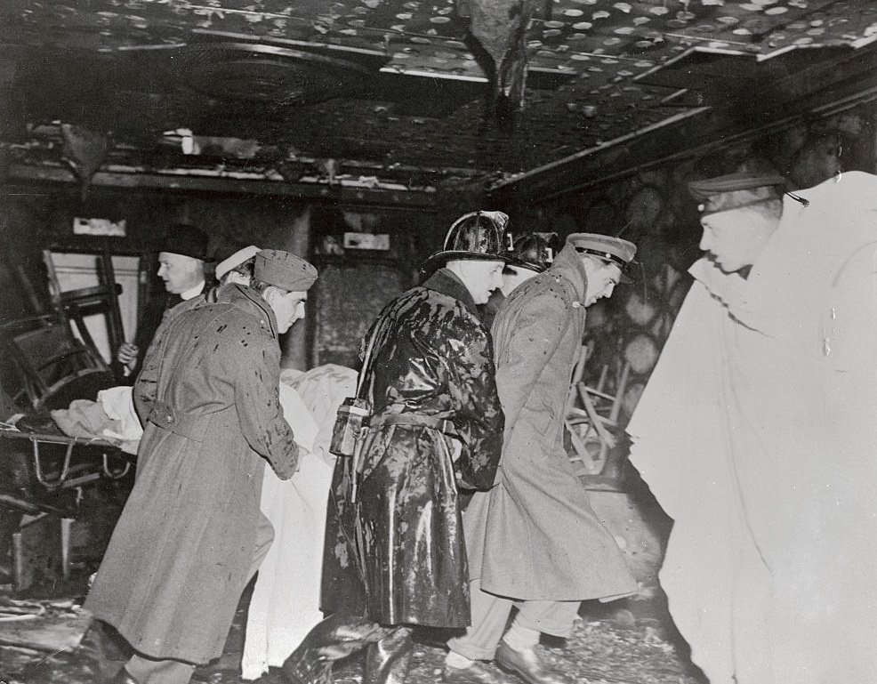 Victim being carried out from Burnt Cocoanut Grove Night Club.