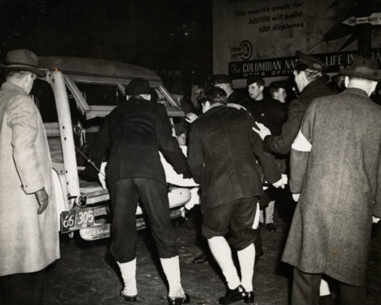Workers carry a victim into an ambulance.
