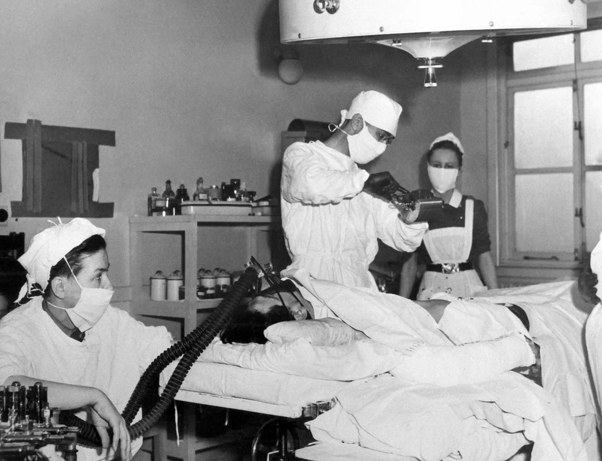 Captain Leyda Sestrap, left, Canadian Army medical officer, administers an anesthetic to a war casualty at a Canadian general hospital in England May 3, 1945.