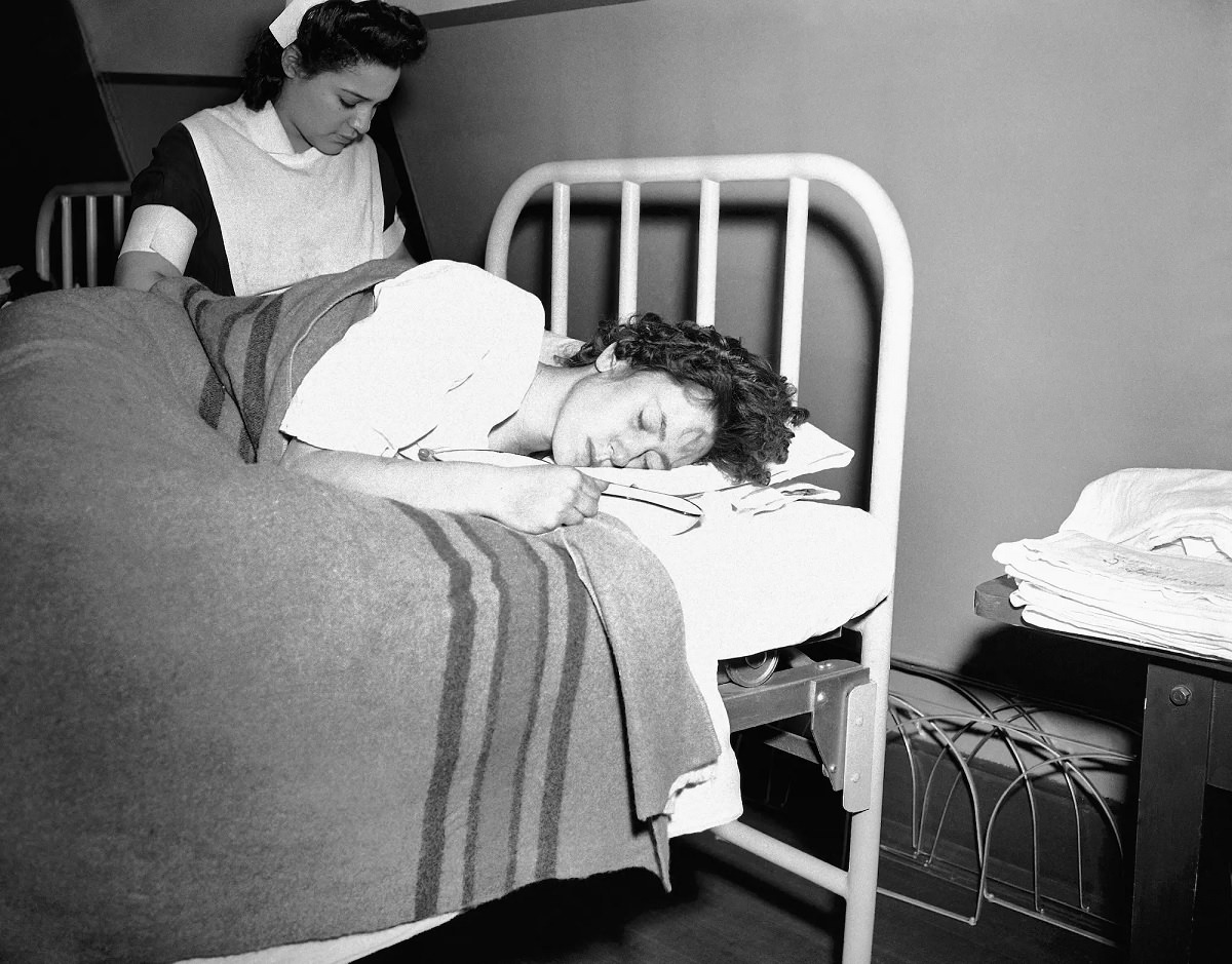 Sophie Urban, of Dorchester, rests in a hospital emergency ward set up in Boston City Hospital, after receiving emergency treatment for burns suffered in flames.
