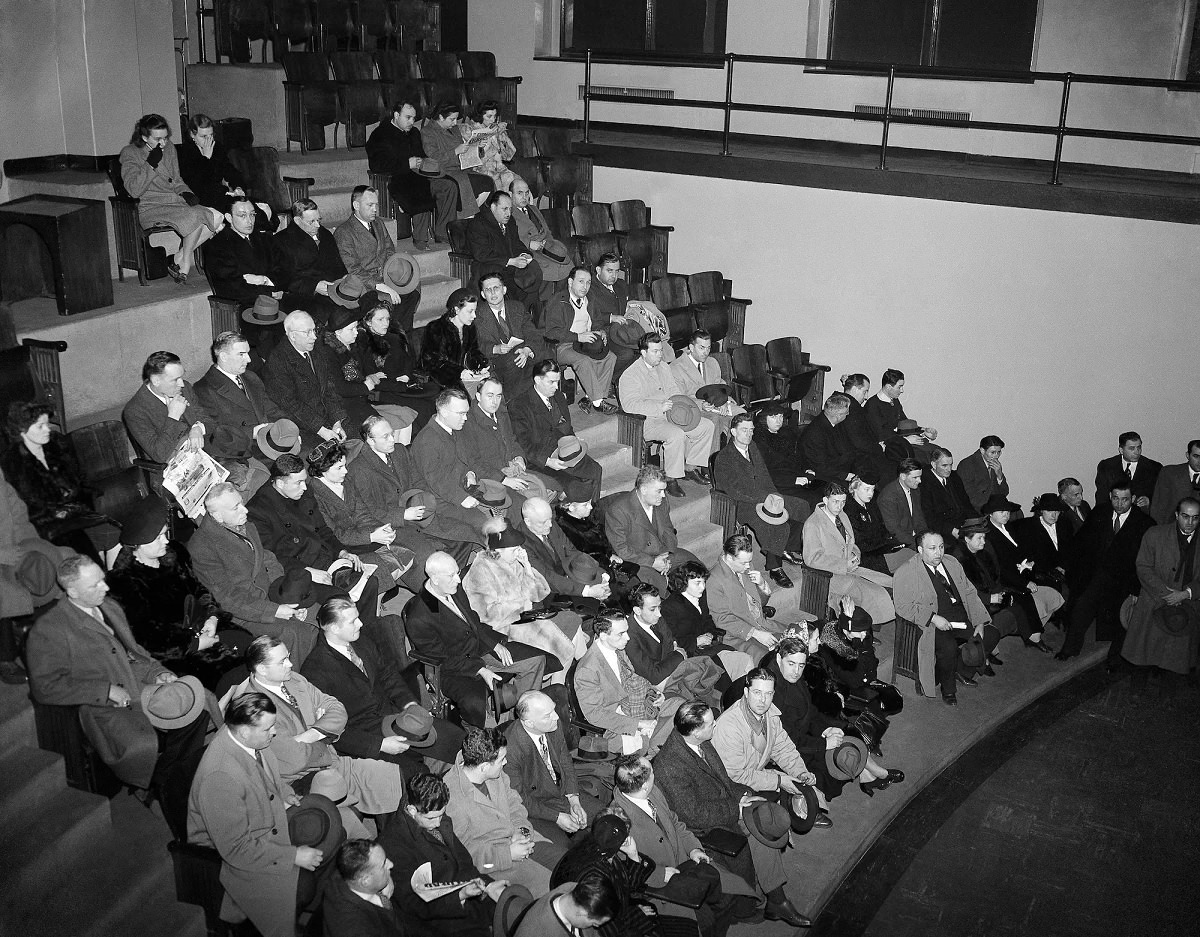 Friends and relatives of persons missing after the Cocoanut Grove Night Club fire in Boston wait in the Amphitheater at the city's Southern Mortuary.