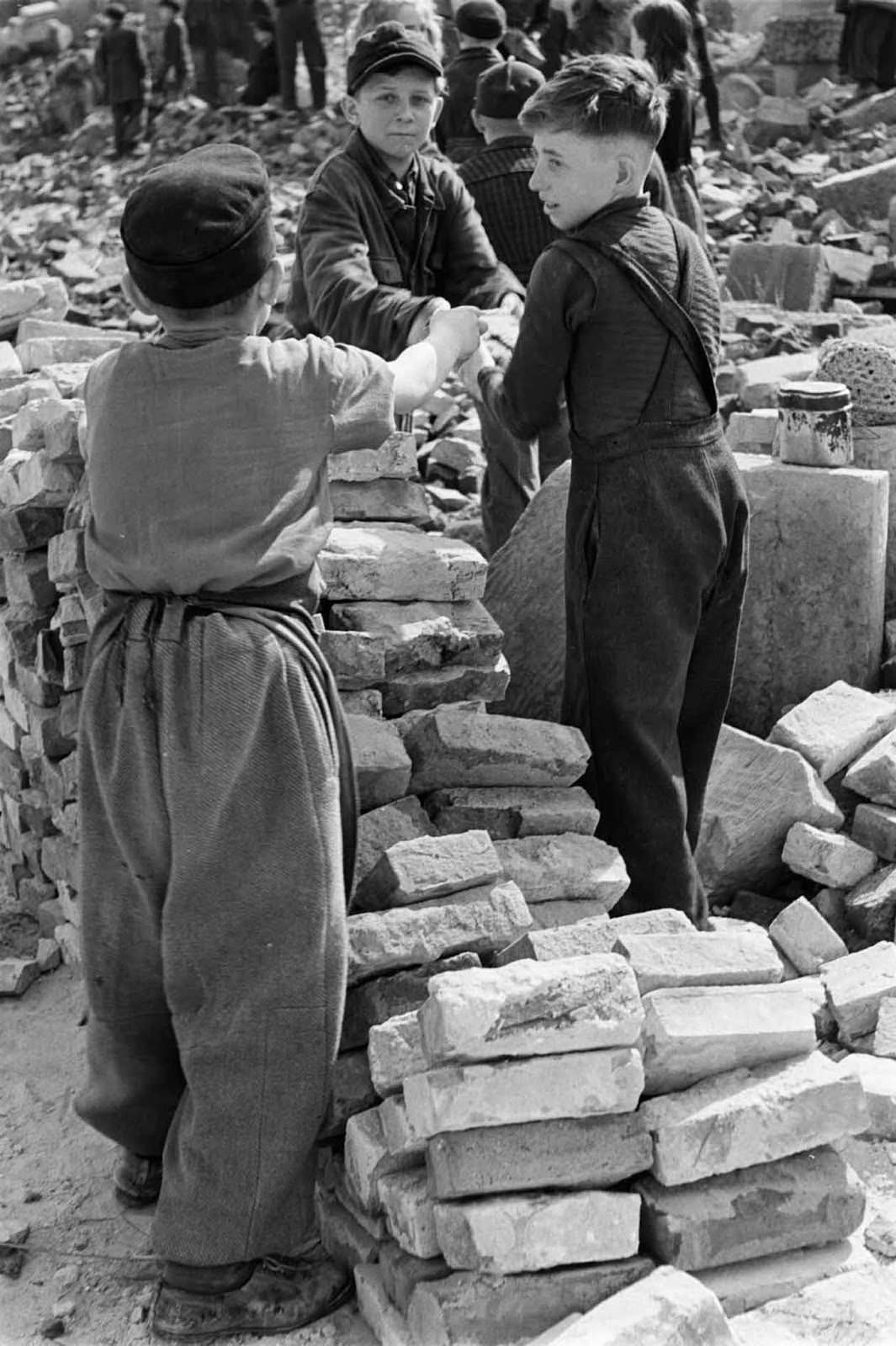 Children cleaning up the ruined city.