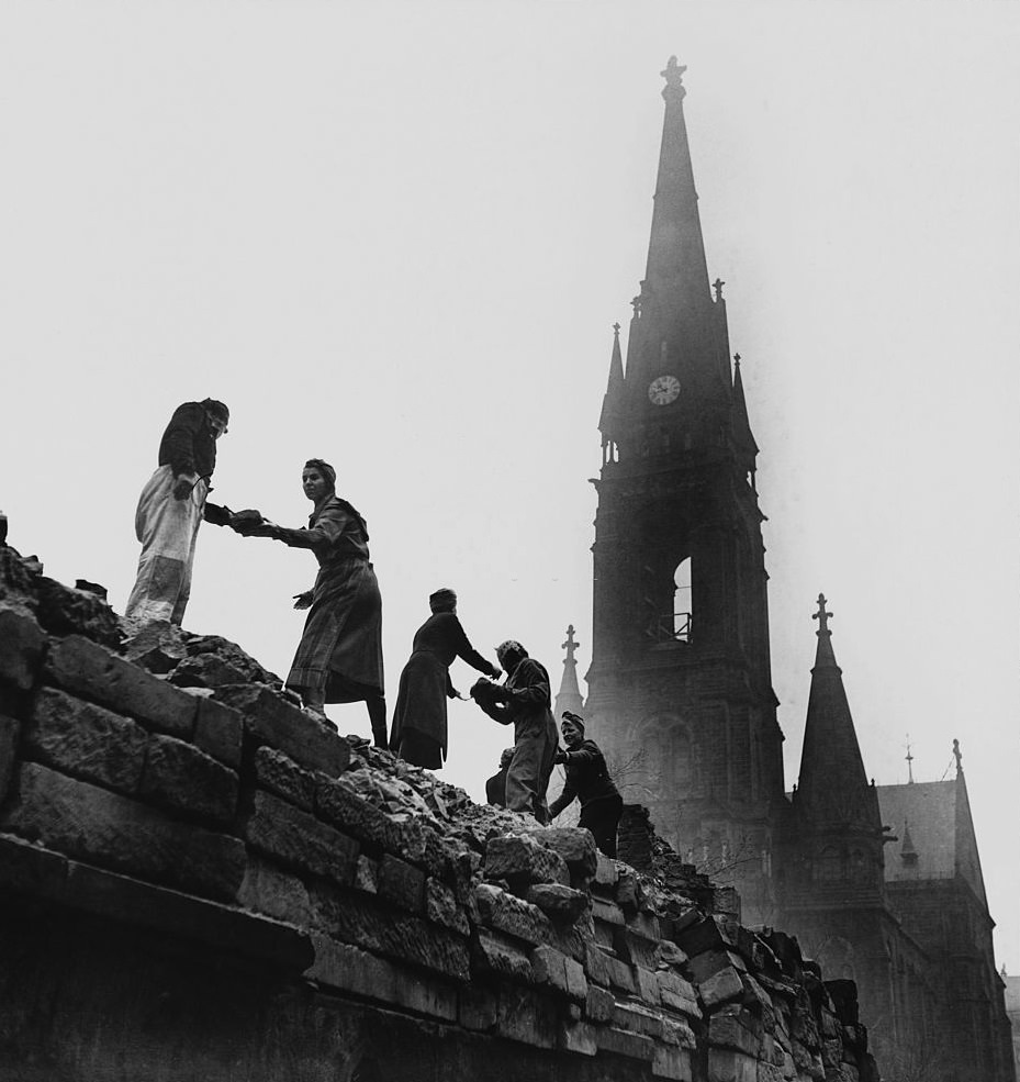 Locals reconstruct a bomb damaged wall, Dresden.