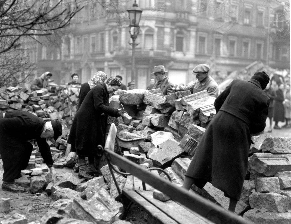 Although Sunday is a day of rest in Dresden volunteers continue to help clear the bomb damage debris, March 1946.