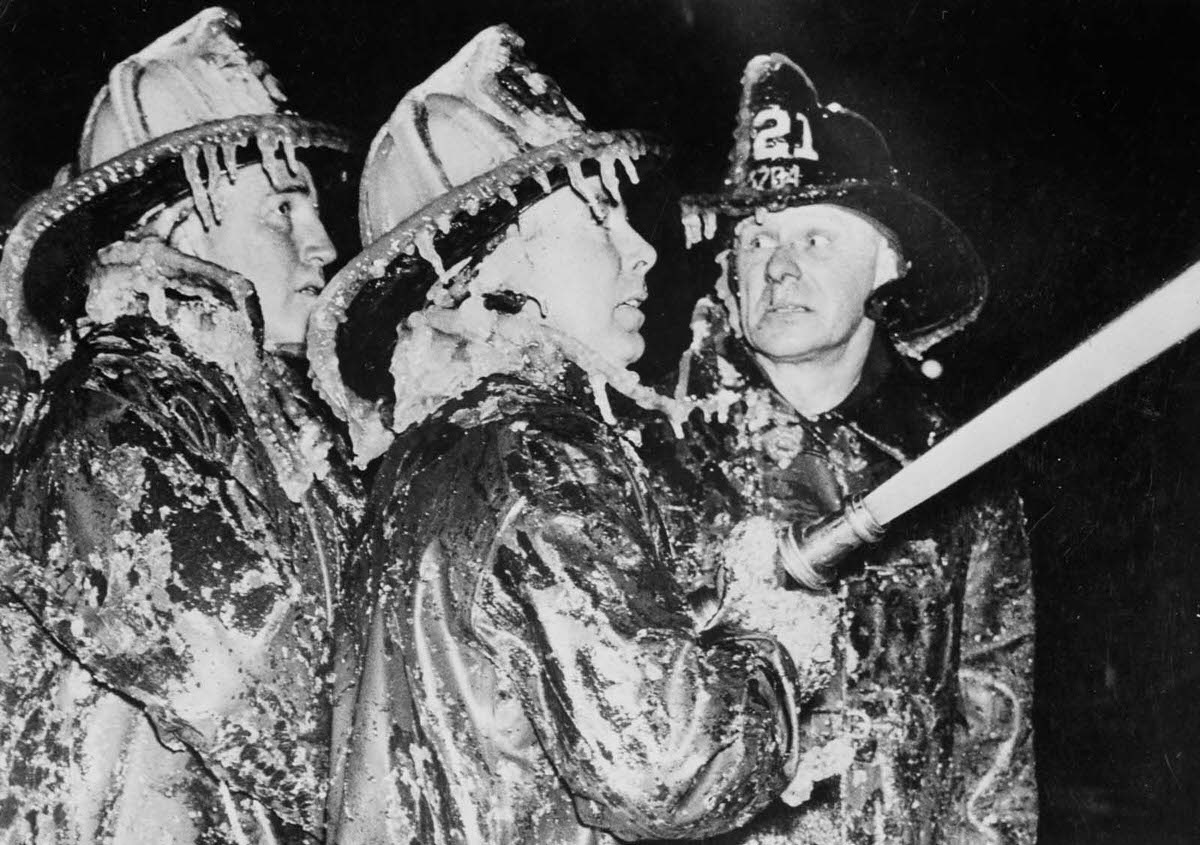 New York firefighters battle a blaze while coated with icicles, 1904.