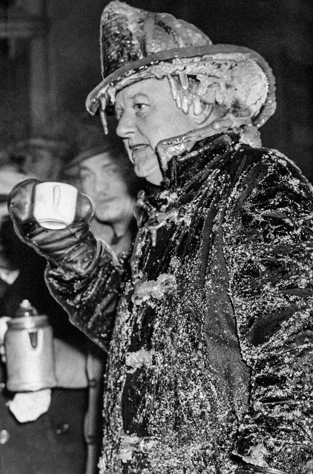 FDNY 35th Battalion Chief William Travers warms up with some coffee at a fire in Brooklyn, 1942.