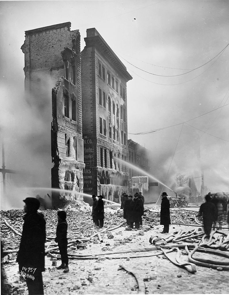 Firefighter put out a fire in downtown Minneapolis on a winter day, 1904.