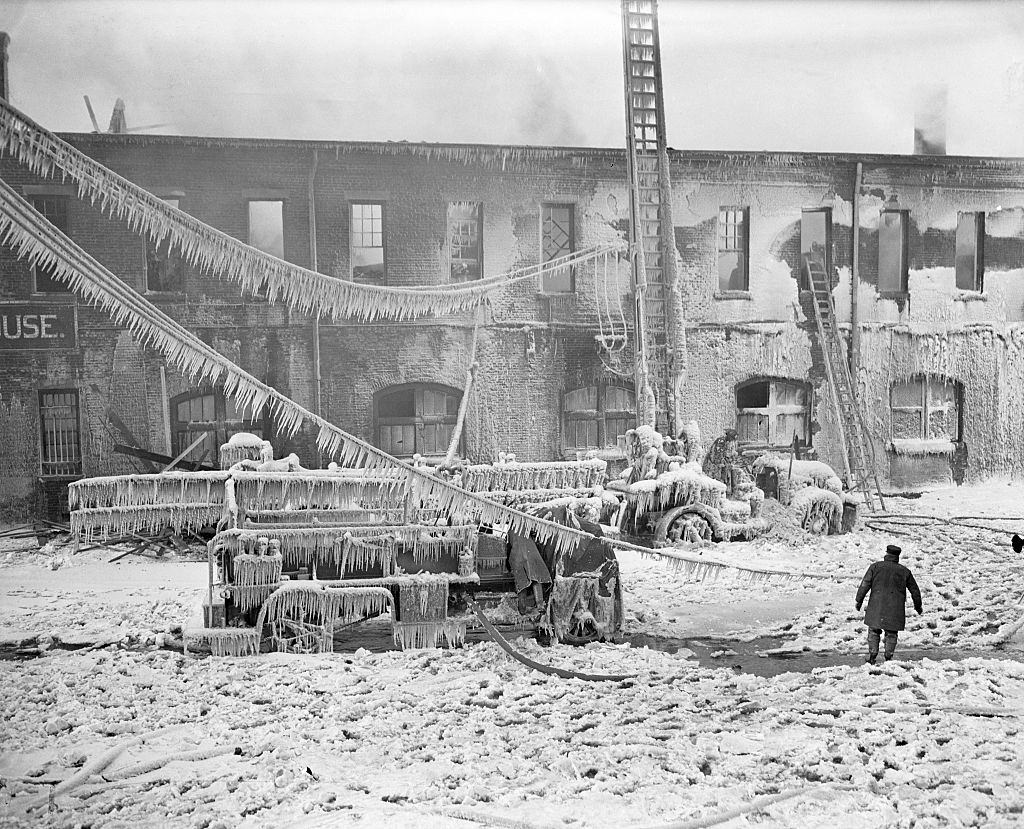 The sudden return of near-zero weather worked a hardship on firemen fighting a blaze at 33rd Street and Eleventh Ave., New York, 1936.