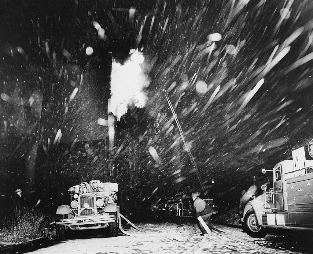 A fire truck arrives at the site of a fire during a snowstorm in New York, 1940.