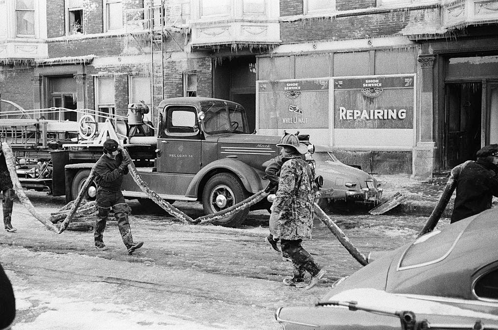 In freezing temperatures, firefighters battle a blaze, Chicago, Illinois, 1958.